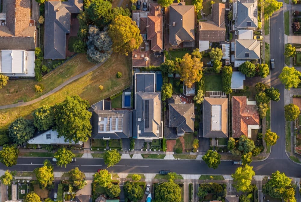 A top down aerial of a suburban block at golden hour, generated without a drone being flown