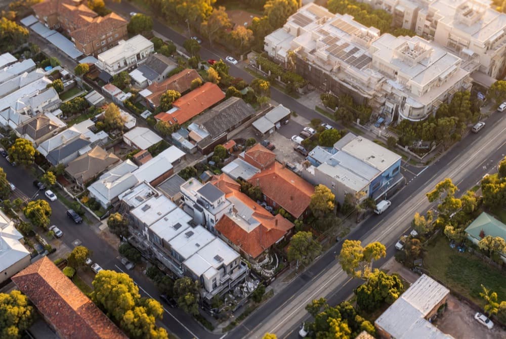 An oblique aerial of a suburban street at golden hour